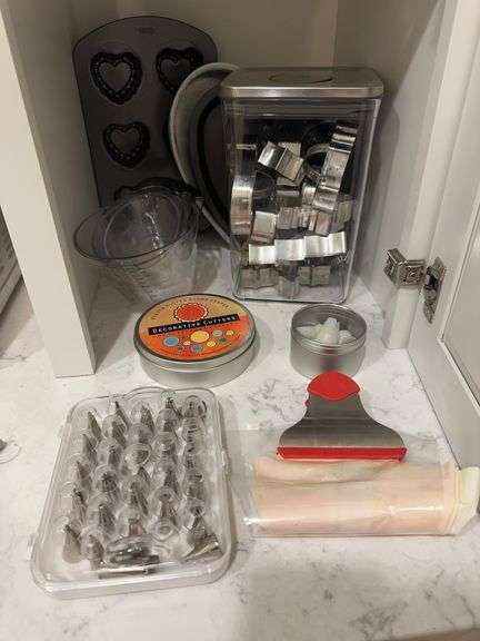 Lot of cookie cutters, measuring cups, icing bags and tips, heart shaped pans including muffin pan, 2 plastic containers image