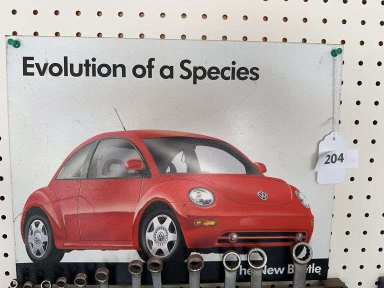 Metal signs, Alaska license plate, vintage calendar, magnetic strips. Excludes wrenches image