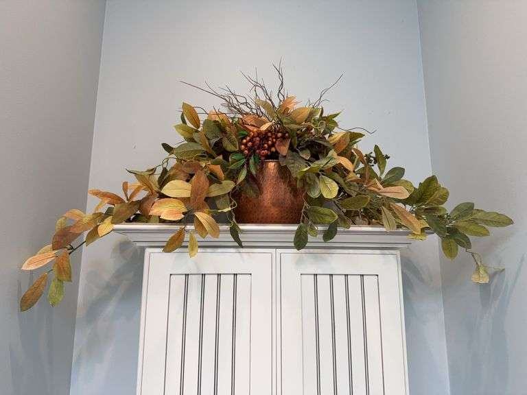 Artificial floral arrangement in copper vase ￼ image