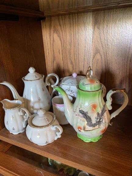 Flur de lis teapot, sugar and creamer, painted dragon teapot, porcelain teapot and cup (damaged) image