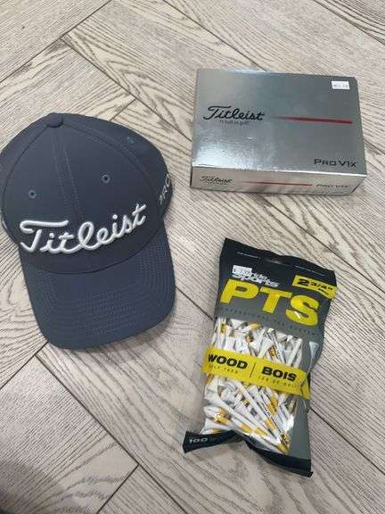 Titleist hat, box of Titleist Pro V1x golf balls, bag of Sports Pride golf tees, Titleist golf umbrella image