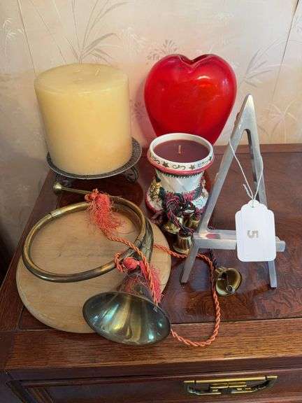 Decorative brass horn, brass bells, candles, red glass vase