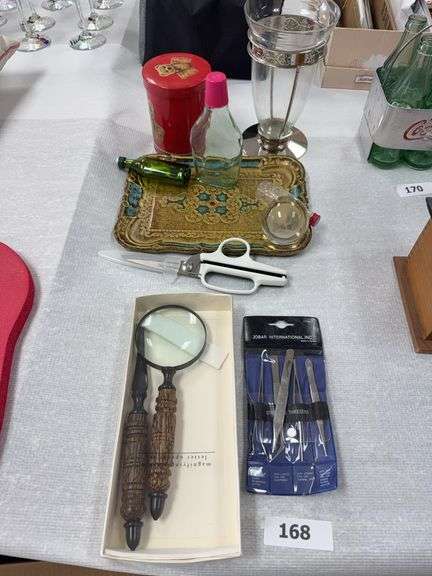 Magnifying glass, letter opener, tweezer set, tin, kitchen shears, bottles, vase, tray image