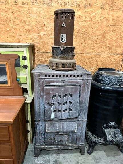 Vintage PERFECTION kerosene heater and vintage cast iron wood burning stove image