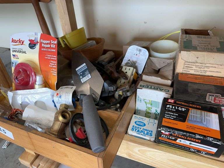Bottom shelf of misc nails and hardware image