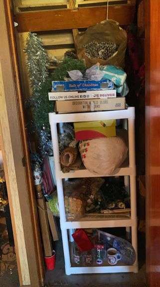 Closet of Christmas decorations, wreath on door image