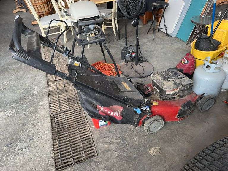 Toro Self-Propeled Push Mower with bagger and 1 gal gas jug image