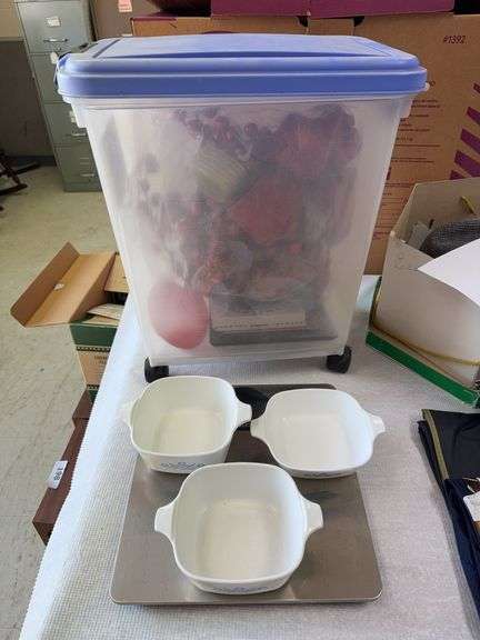 Homemedics scale, rolling tub with 3 small Corningware casserole dishes, trivets, misc image