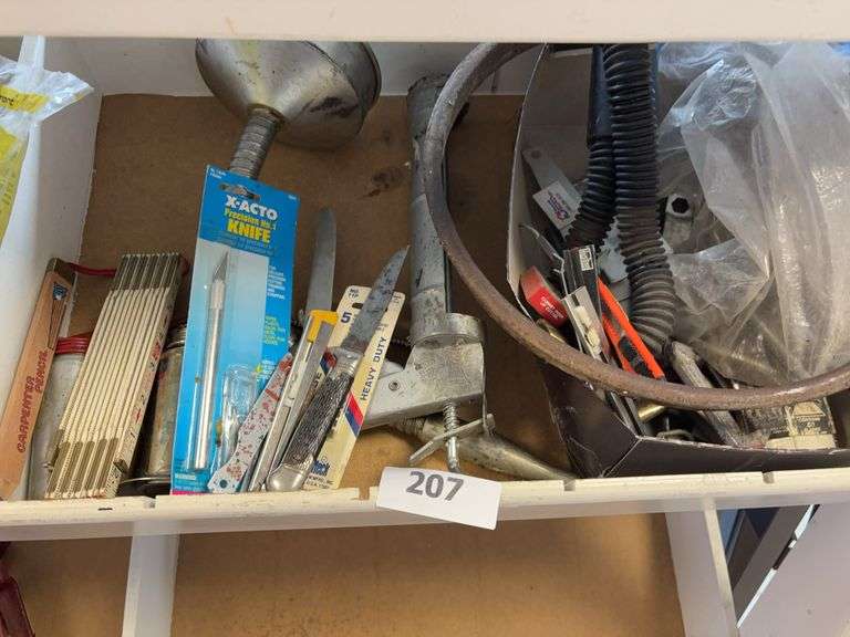 Oil cans, ruler, knife, caulking gun, misc image