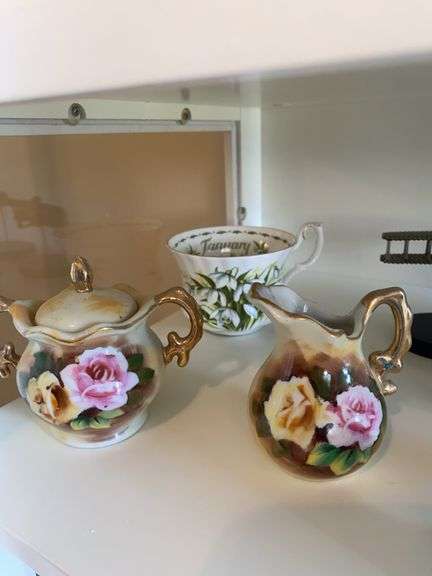 Goebel angel, Fenton duck, glass rabbits, delft blue cow creamer, Dept 56 figurines, miscellaneous ( February tea cup broke) 4th shelf