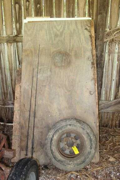 Firewood Rack, Various Sized Pieces of Firewood, (2) Fishing Rods, and Buckshot 31x10 50R15LT Tire image