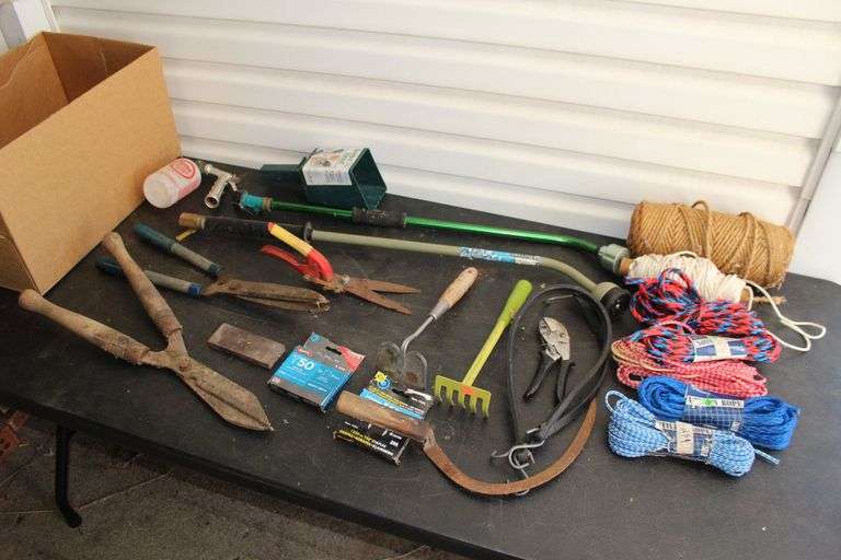 Pruners, Utility Rope, Bungee Cords, Hand Scythe, Sharpening Stone, Water Hose Attachments, Staples, and Misc. image
