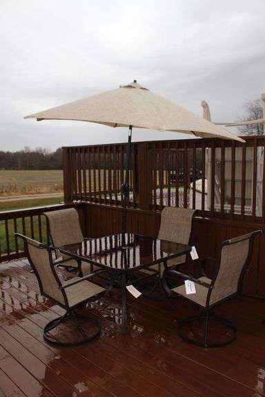Glass Top Patio Table, (4) Swivel Chairs, Crank Umbrella, and Umbrella Stand image