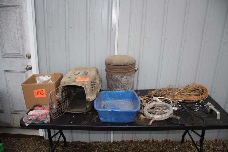 Animal Crate, Fishing Bucket, String, Bungee Cords, Knife Sharpener, Tail Lights, and Steering Wheel For Boat image