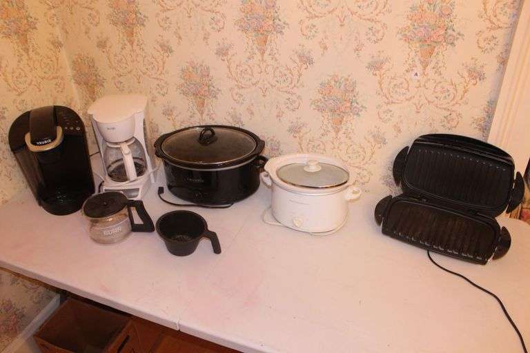 Hamilton Beach Slow Cooker, Crock Pot Slow Cooker, Keurig Coffee Maker, George Foreman Electric Grill, Mr. Coffee Coffee Maker, Bunn Coffee Pot, and Filter Cup image