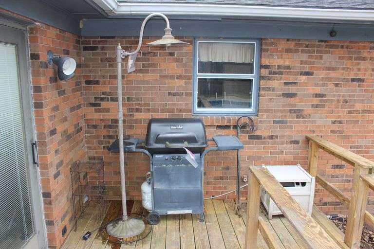 Shepherd Hooks, Metal Shelf, Garden Hose Reel, and Quickset Grill With Tank image