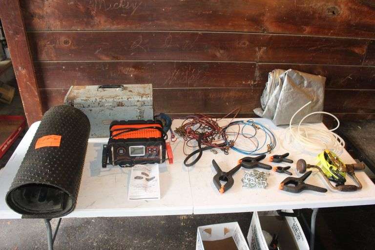 Craftsman Metal Tool Box, Black and Decker Battery Charger, Tarp, Dog Chains, Clamps, Ratchet Straps, Refrigerator Water Line, Truck Bed Mat Piece, and Misc. image