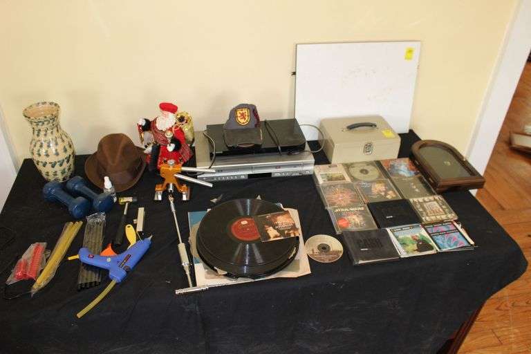 Records, CDs, Metal Money Box, Santa Claus Figurine, Hot Glue Gun, Vase, Hats, Samsung, VHS/DVD Player, Samsung DVD Player, and Misc. image