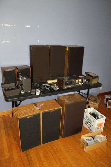 (2) Klipsch Speakers, (2) Realistic Speakers, (2) Cygner Speakers, (2) Panasonic Speakers, Sharp Stereo Cassette Deck, Tape Case, Bell and Howell 8mm Super 8 Projector, Remotes, Electrical Cords, and Misc. image