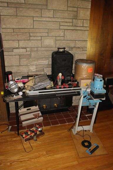 Beseler 23C 2 XL Photo Enlarger and Parts, Suitcase, Roller Skates, Bed Rails, Light Bulbs, Working Light, GR-72 Time of Lite, Cardboard Barrel, and Misc. image