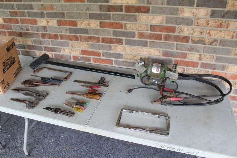 Central Machinery Bench Grinder, (2) License Plate Covers, Square, 14 Inch Fuller Pipe Wrench, Jumper Cables, Screw Drivers, Shears, Draw Knife, and Misc. image