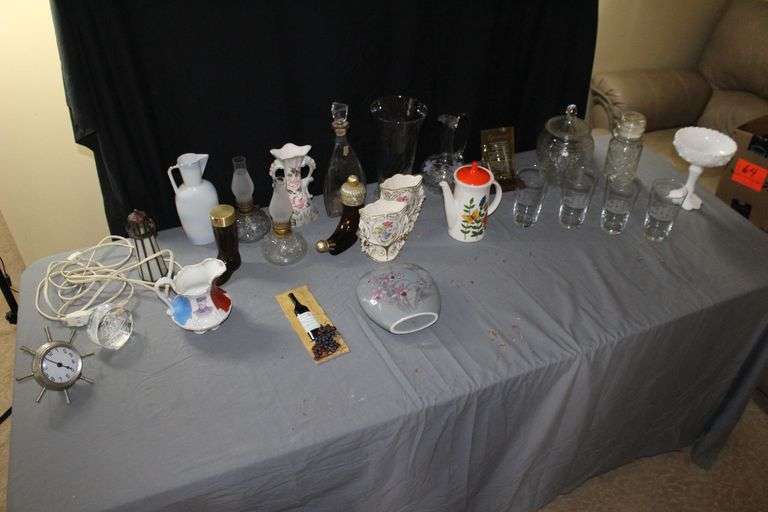 (2) Oil Lamps with Globes, Lighted Lighthouse, (4) Boat Glasses, Glass Cookie Jar with Lid, Pitchers, and Misc. image