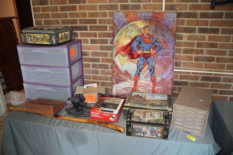 Sterilite 3 Drawer Plastic Containers, Walking Stick, Squirrel Nut Cracker Plate, 6 Drawer Metal Filing Cabinet, German Cookie Tins, Sharp Adding Machine, and Superman Decoration image
