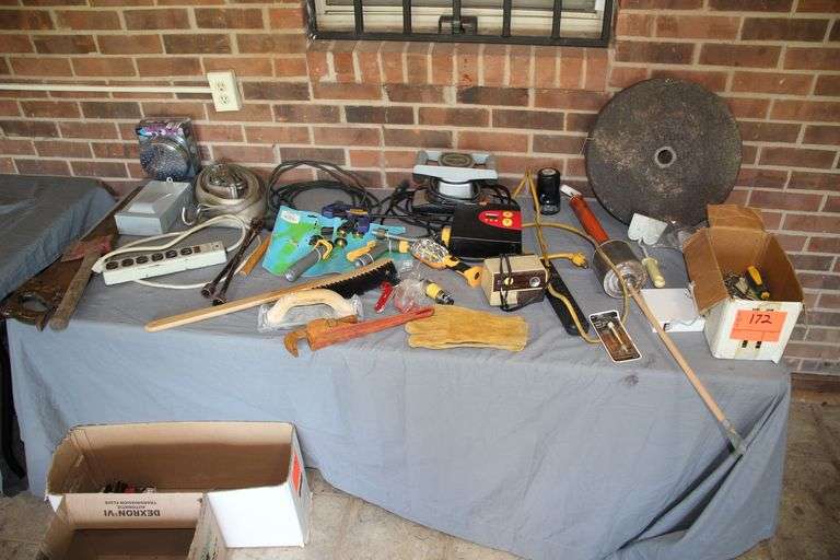 16 Inch Grinding Wheel, Ratchet Strap, Electrical Cords, Power Strips, Rubber Mallet, Water Hose Attachments, Grease Gun, Hand Saw, Morfam Back Massager, 14 Inch Pipe Wrench, and Misc image