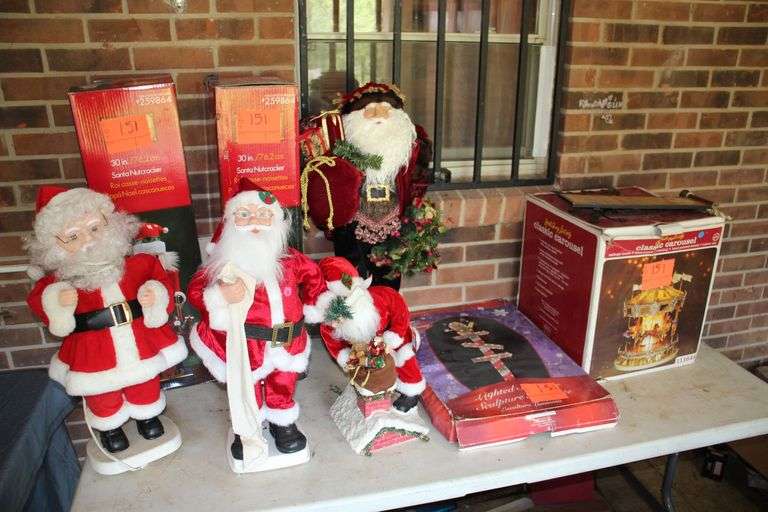 (2) 30 Inch Nutcrackers, (4) Santa Claus Figurines, Holiday Living Classic Carousel, and Disney Lighted Sign Post image