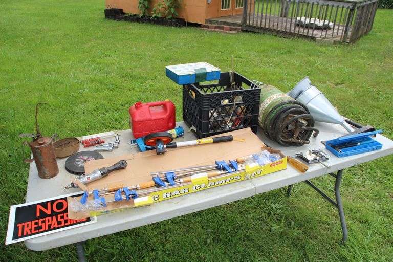 No Trespassing Signs, Universal Tool 3/8 Inch Air Ratchet, 1000 Ft Measuring Wheel, Bar Clamps, Goldenrod Oil Can, Pry Bar, Caulk Gun, Rivet Gun, (2) Milk Crates, Gas Can, Funnels, Mallet, Ratchet and Sockets, and Misc image