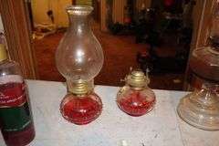 (2) Oil Lamps with Globes, Oil Lamp Base, (3) Rollers, Lamp Oil, Iron, Glass Goblet, and Wooden Calendar