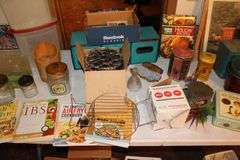 Cake Plate Carrier, Tins, Thomas Collector Edition Radio, Glass Canisters, Plastic Canisters, Framed Puzzle, Yard Stick, Books, and Misc.