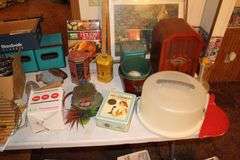 Cake Plate Carrier, Tins, Thomas Collector Edition Radio, Glass Canisters, Plastic Canisters, Framed Puzzle, Yard Stick, Books, and Misc.