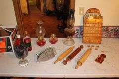 (2) Oil Lamps with Globes, Oil Lamp Base, (3) Rollers, Lamp Oil, Iron, Glass Goblet, and Wooden Calendar