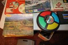 X-Acto Paper Cutter, Monopoly Games, Jigsaw Puzzles, Board Games, Wii Fit Board, Cassette Case, Cassettes, Sony Cam Recorder, Oculus VR Headset and Remote, and Misc.