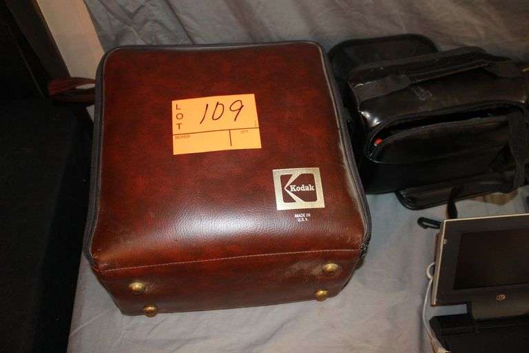 DVD Cases, Belmont Binoculars, Kodak Record Player, DVD Player, Clock Radio, Headphones, Camera Bag, and Misc.