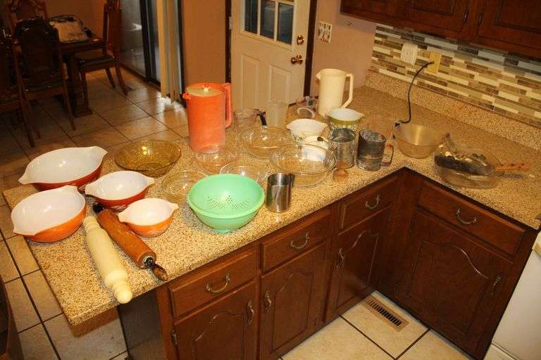 Pyrex Mixing Bowls, Plastic Measuring Cups, Glass Bowls, Strainer, (2) Sifters, Biscuit Cutters, and Misc. image
