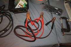 (4) Power Strips, Pittsburgh 2 Ton Jack, Jumper Cables, Electrical Cords, Fan, C-Clamp, Zip Ties, Tire Tool, and Misc.