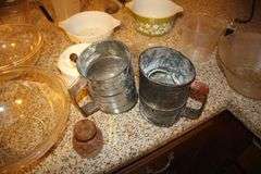 Pyrex Mixing Bowls, Plastic Measuring Cups, Glass Bowls, Strainer, (2) Sifters, Biscuit Cutters, and Misc.