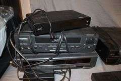 Daewoo VHS Player, Arris HDMI Box, Sony Blu Ray Player, VHS Player, TV Remotes, Candles, Kinyo VHS Tape Player, Protron DVD Player, Iron, and Misc.