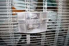 (2) Folding Cots, Standing Heater, Fan, Metal Flower Stand Bench, Kingsford Charcoal, and Type 1 Tile Adhesive