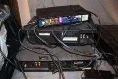 Daewoo VHS Player, Arris HDMI Box, Sony Blu Ray Player, VHS Player, TV Remotes, Candles, Kinyo VHS Tape Player, Protron DVD Player, Iron, and Misc.
