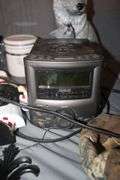 (4) Canisters with Sealing Lids, (4) Decorative Canisters, Wolf Statue, Alarm Clock, Wall Decorations, Tape Cleaner, and Misc.