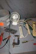 (4) Power Strips, Pittsburgh 2 Ton Jack, Jumper Cables, Electrical Cords, Fan, C-Clamp, Zip Ties, Tire Tool, and Misc.