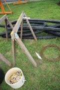 (2) Saw Horses, Cable, (2) Flower Pots, (4) Pieces of 4 Inch Drain Pipe, and Misc. Rope Pieces