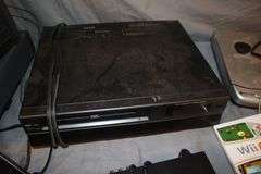 Daewoo VHS Player, Arris HDMI Box, Sony Blu Ray Player, VHS Player, TV Remotes, Candles, Kinyo VHS Tape Player, Protron DVD Player, Iron, and Misc.
