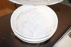 (2) Folding Cots, Standing Heater, Fan, Metal Flower Stand Bench, Kingsford Charcoal, and Type 1 Tile Adhesive