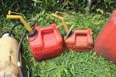 1 Gallon Gas Can, (2) 2 Gallon Gas Cans, 5 Gallon Gas Can, and (2) Sprayers