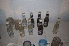 Glass Soda Bottles, 1993 Derby Glass, Coffee Mugs, Power Strip, Milk Crate, and Misc.