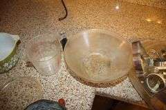 Pyrex Mixing Bowls, Plastic Measuring Cups, Glass Bowls, Strainer, (2) Sifters, Biscuit Cutters, and Misc.